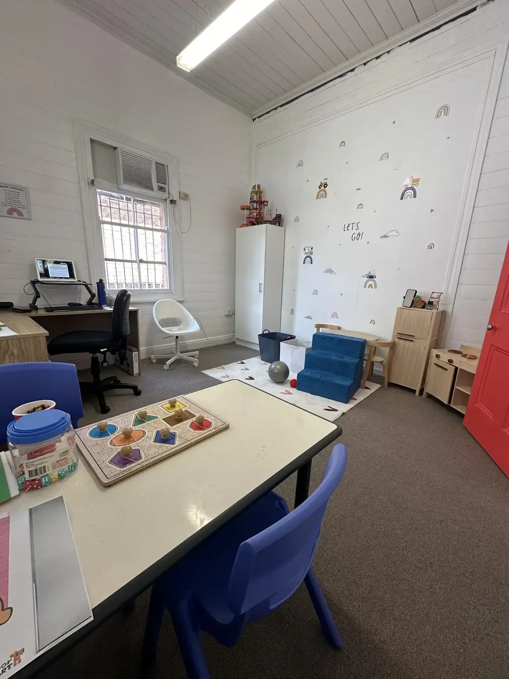 A light-filled Sunshine therapy room prepared with play and learning materials